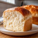 Close-up of a slice showing the incredibly soft, fluffy crumb texture of homemade japanese milk bread.