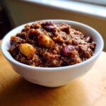 Close-up of a thick, rich bowl of chili featuring kidney beans and lighter beans, showcasing the best chili recipe texture.