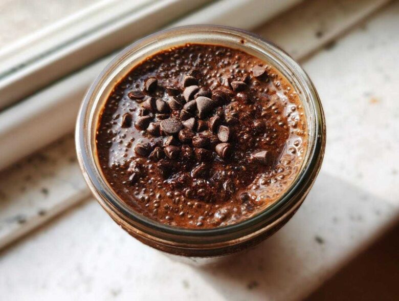 Overhead view of rich, dark chocolate overnight oats topped generously with mini chocolate chips.
