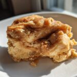 A dollop of fluffy, cinnamon-swirled Copycat Texas Roadhouse Cinnamon Honey Butter on a white plate.