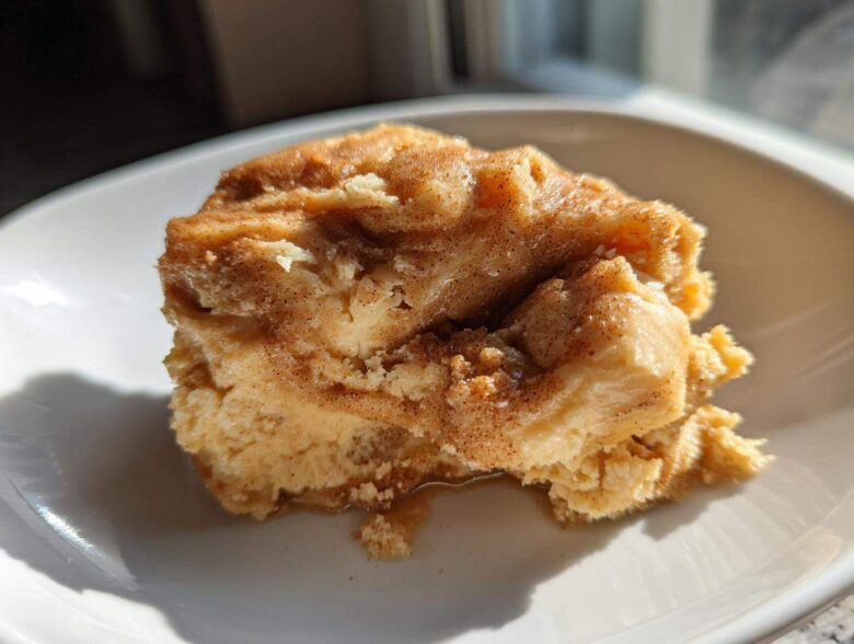 A dollop of fluffy, cinnamon-swirled Copycat Texas Roadhouse Cinnamon Honey Butter on a white plate.