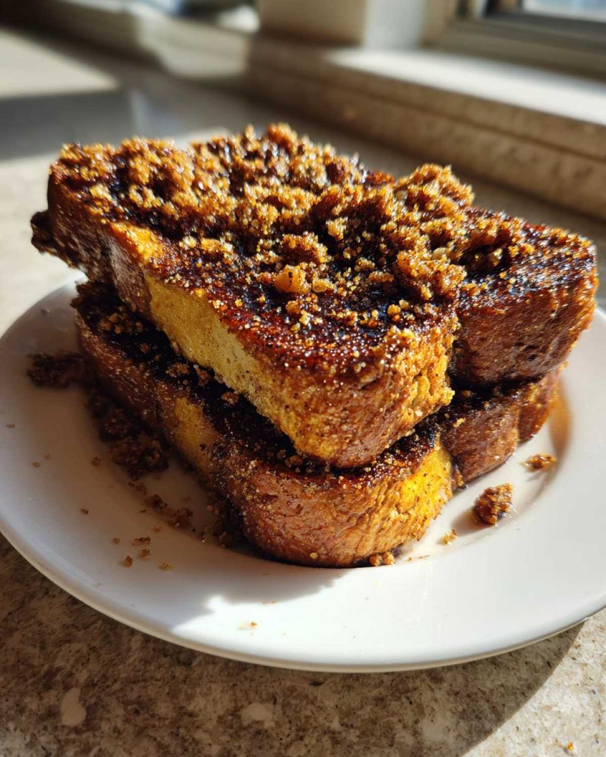 Close-up of stacked Gluten-Free Cinnamon Crunch French Toast generously topped with brown sugar crumble.