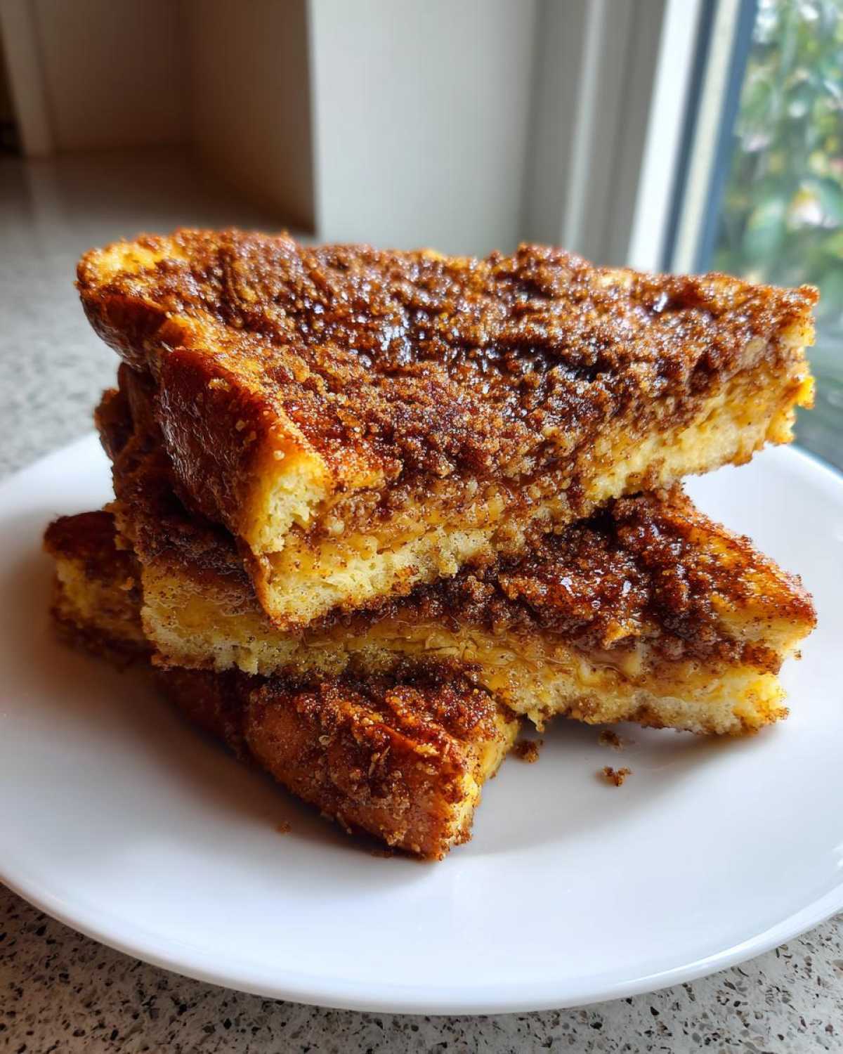 Stack of three slices of Gluten-Free Cinnamon Crunch French Toast with a thick, sugary crust.
