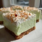 Close-up of a square No-Bake Coconut Lime Bars slice showing graham cracker crust, lime filling, and toasted coconut.