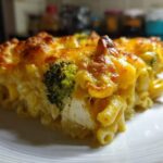 Close-up of a hearty slice of Cheesy Chicken and Broccoli Pasta Bake with a golden, bubbly cheese crust.