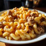 A close-up serving of Cheesy Ground Beef Pasta with Creamy Sauce featuring cavatappi pasta mixed with seasoned ground beef.