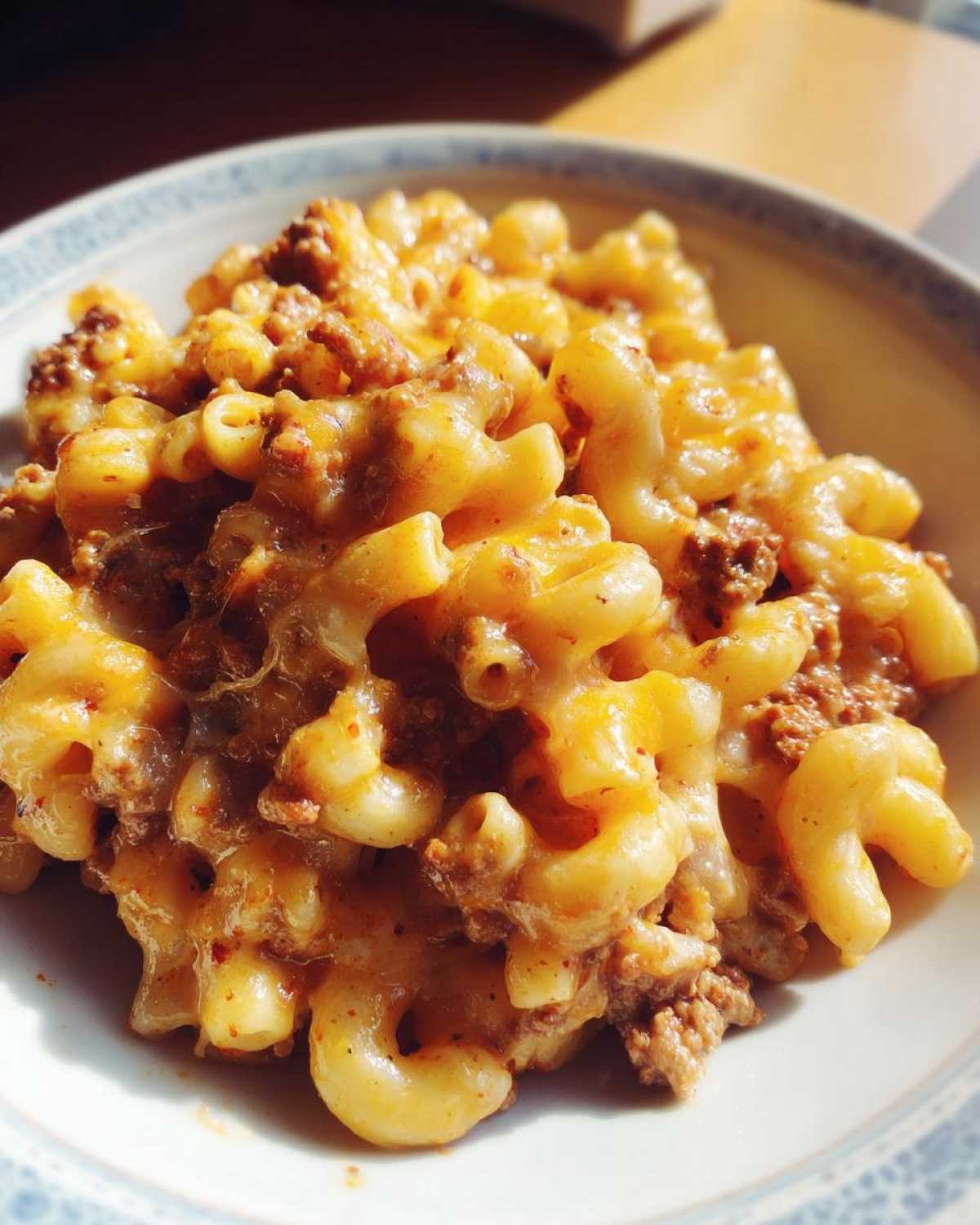 Close-up of a bowl filled with Cheesy Ground Beef Pasta with Creamy Sauce, featuring elbow macaroni and seasoned ground beef.