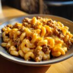 A close-up, appetizing shot of Cheesy Ground Beef Pasta with Creamy Sauce featuring elbow macaroni coated in melted cheese and ground beef.
