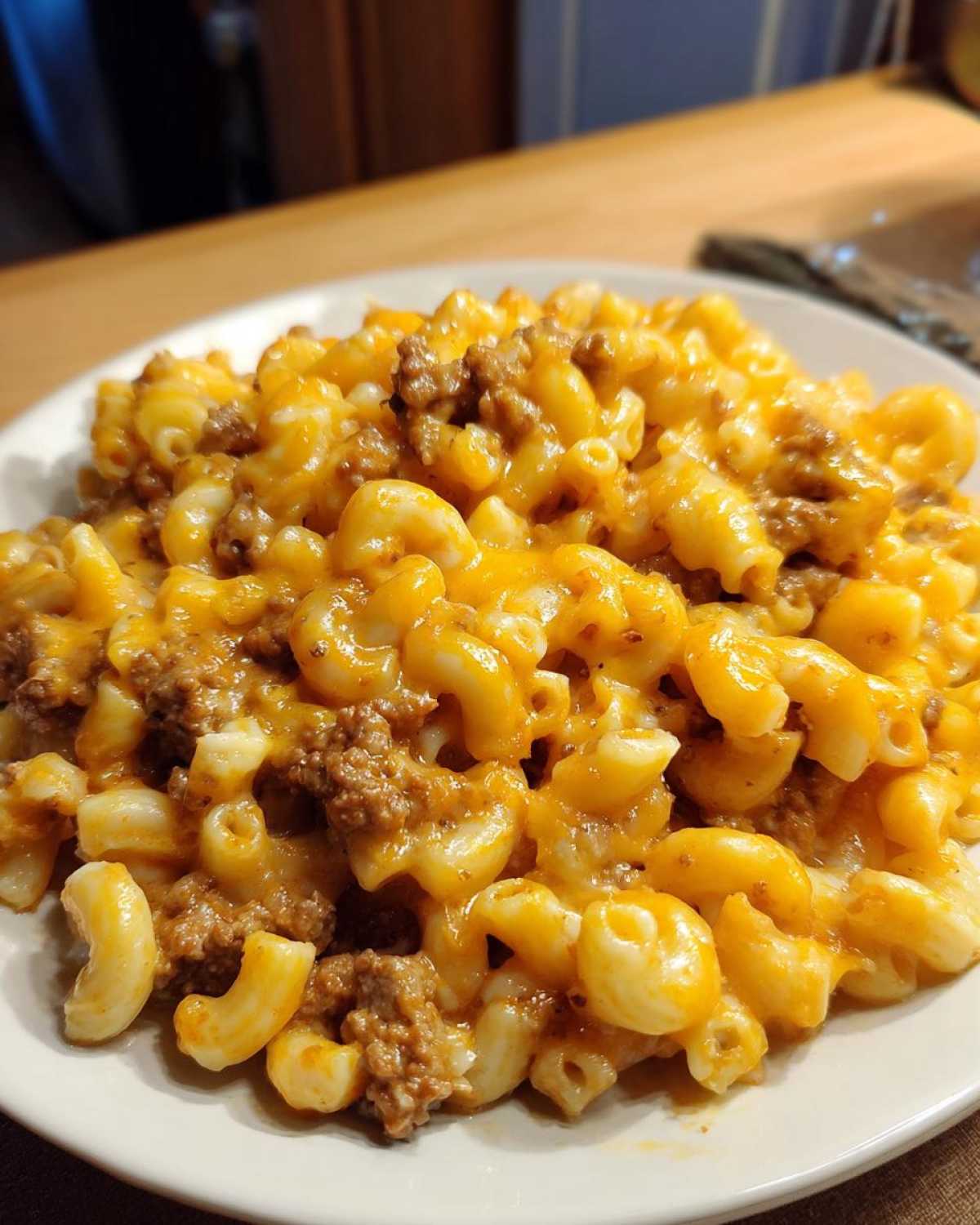 A close-up shot of Cheesy Ground Beef Pasta with Creamy Sauce featuring elbow macaroni mixed with ground beef and melted cheddar cheese.