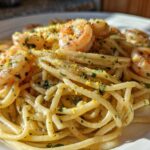 Close-up of Creamy Lemon Shrimp Pasta with Garlic Sauce, topped with shrimp and lemon zest.