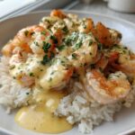 Close-up of a Garlic Butter Shrimp Rice Bowl featuring plump shrimp covered in a creamy garlic sauce and parsley over white rice.