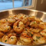 Close-up of juicy shrimp cooked in a Garlic Butter Shrimp Skillet with lemon sauce and fresh parsley.