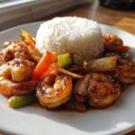 A serving of Honey Garlic Shrimp Skillet with Rice, featuring glazed shrimp and vegetables next to a mound of white rice.