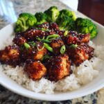 Close-up of Honey Soy Garlic Chicken with Rice Bowl, featuring glazed chicken pieces over white rice with broccoli and sesame seeds.
