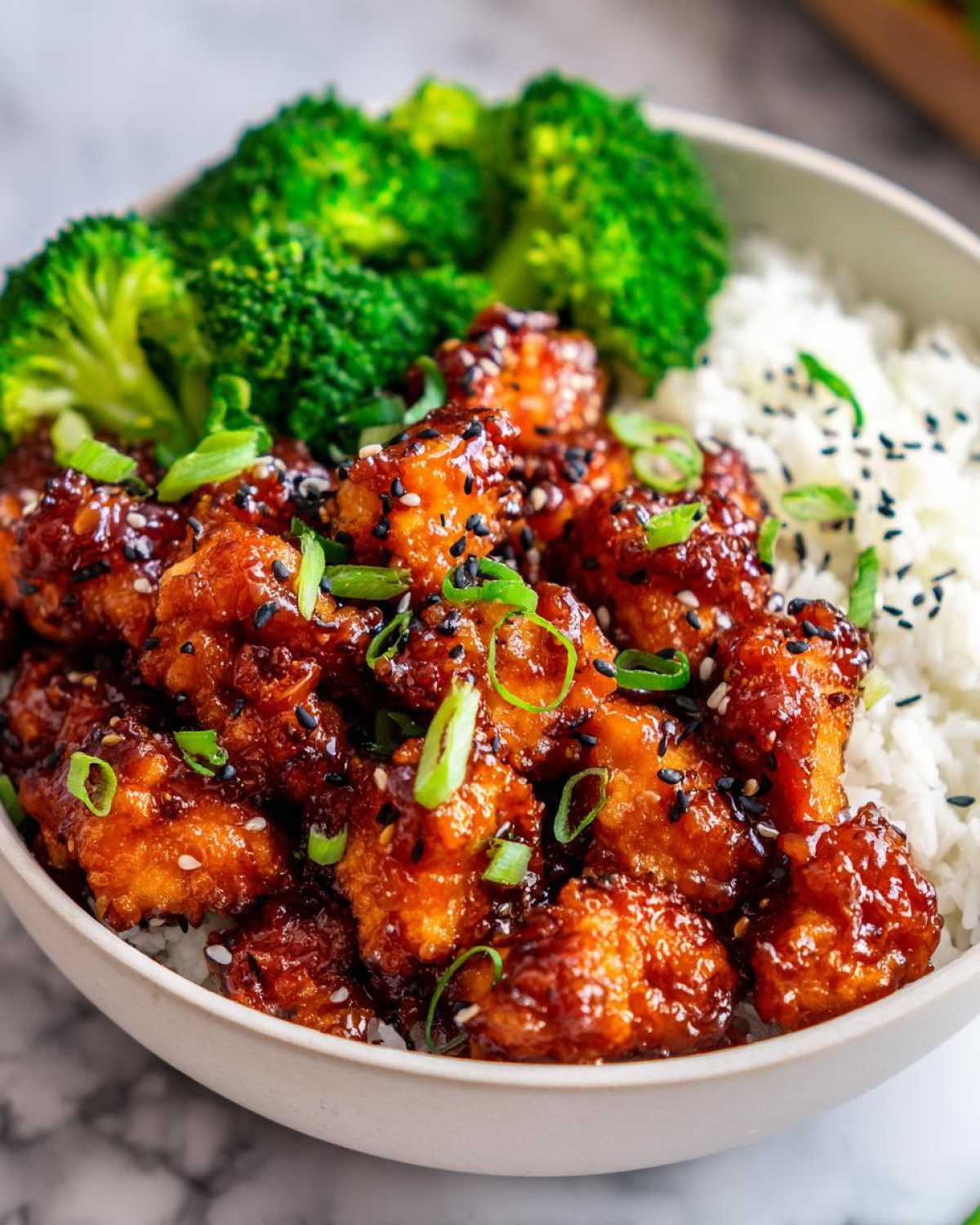 Close-up of Honey Soy Garlic Chicken with Rice Bowl, featuring glazed chicken, white rice, and steamed broccoli.